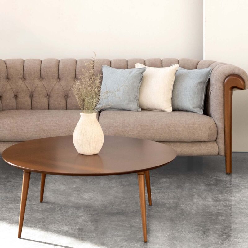 solo round wooden coffee table and cane sofa