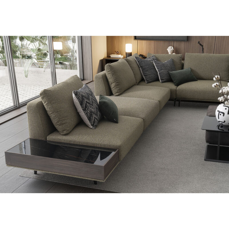 The Loft Modular Sofa in a modern living space with a green accent fabric and a black marble coffee table