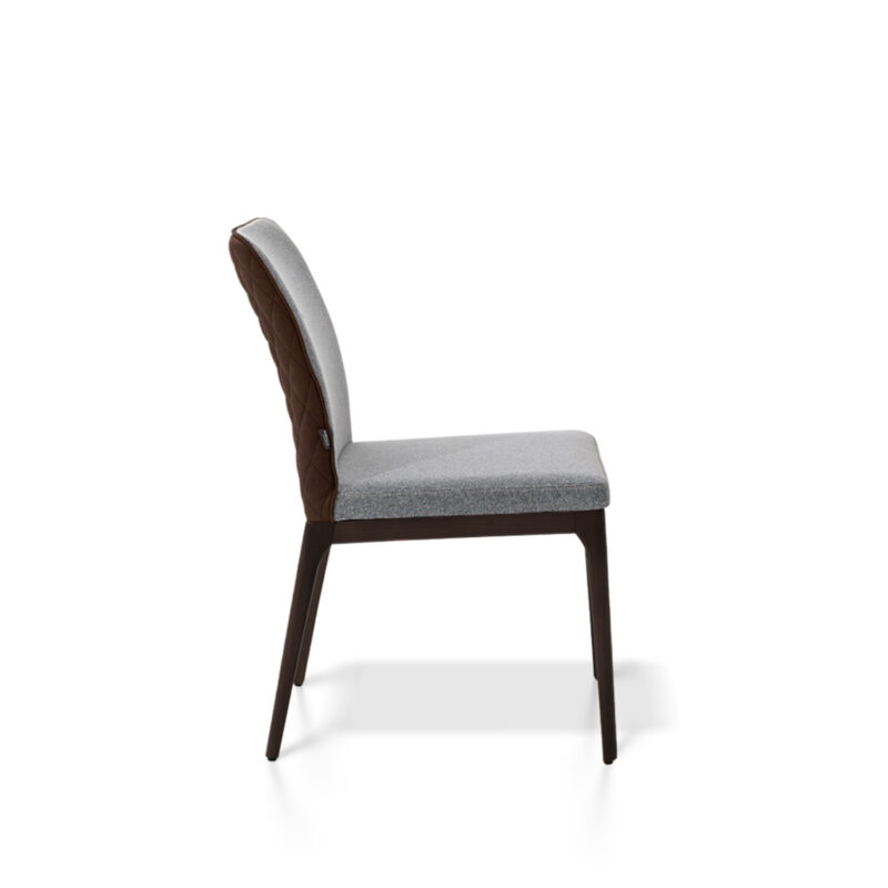 An image of the Toronto Dining Chair on a white background, featuring its solid beech wood legs and tufted backrest
