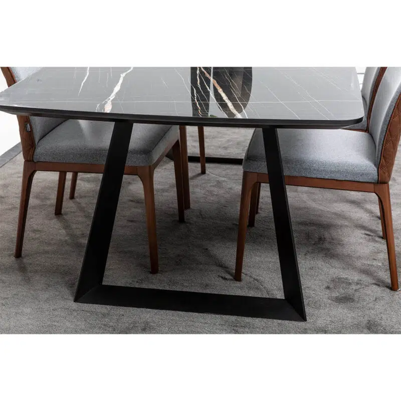 Modern marble dining table with sleek black legs and upholstered chairs, perfect for luxury interiors by LEOPARD Furniture.