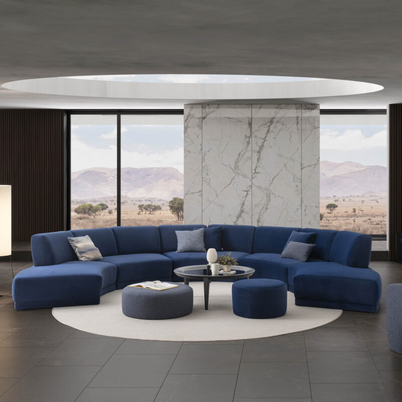 le mans modular sofa in dark blue velvet and two chelsea puffs large and small and vovo charcoal grey round coffee table