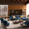 Luxurious blue sectional sofa in rustic living room design by LEOPARD Furniture, Canada. High-end interior elegance.