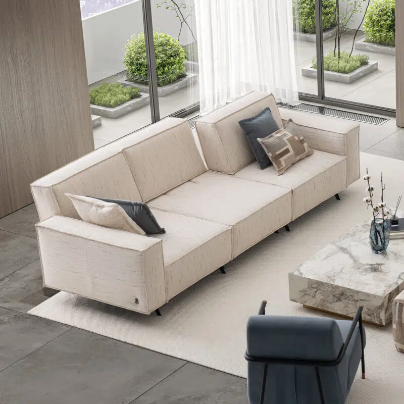 Modern beige sectional sofa and marble coffee table in a contemporary living room by LEOPARD Furniture, Canada.