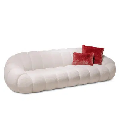 Luxurious white boucle sofa with red pillows on a white background from LEOPARD Furniture, high-end Canadian design.