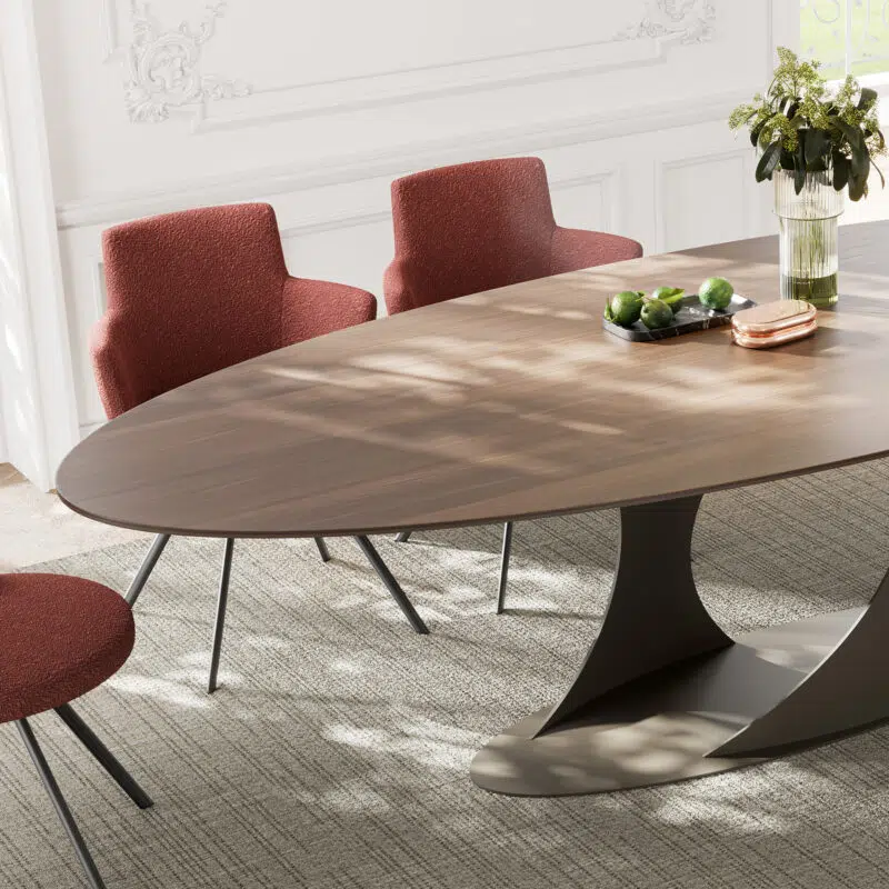 Oval walnut dining table with red upholstered chairs in elegant dining room by LEOPARD Furniture Canada.