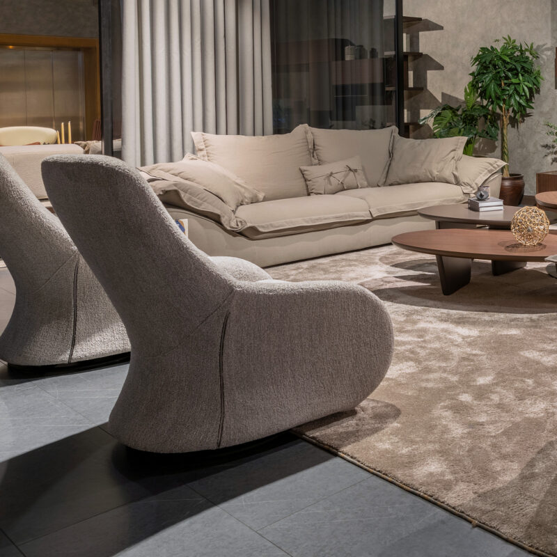 warm contemporary living room with gray all upholstered swivel armchairs