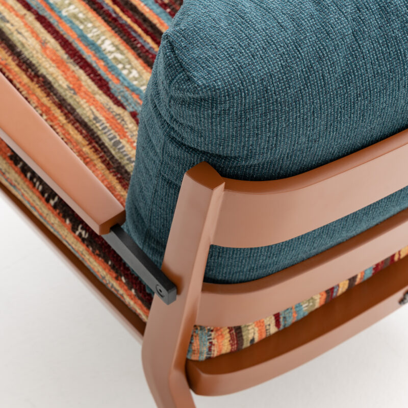 detailed view of wooden armchair with colorful fabric upholstery