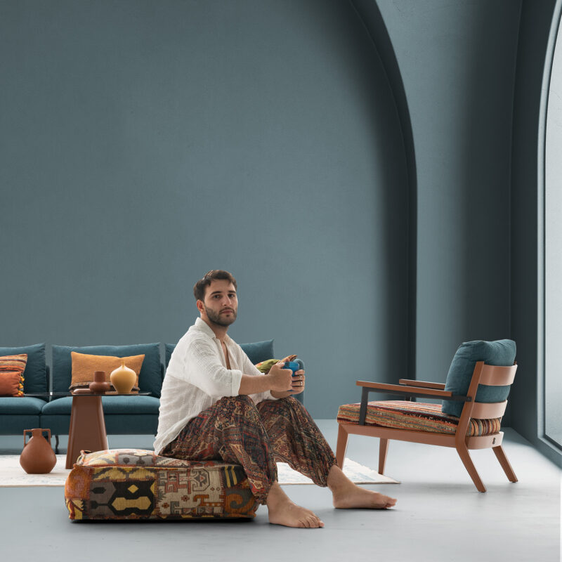 artistic picture of a Wooden armchair modern design with a male model