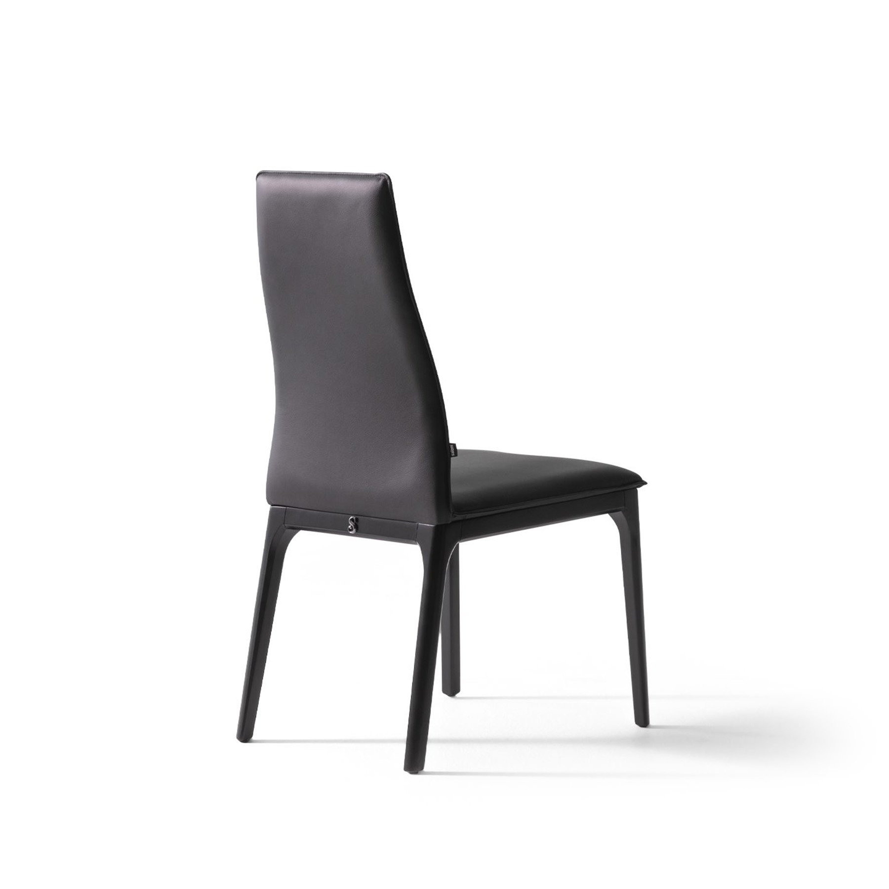 contemporary high back dining chair in black leather back view on a white background