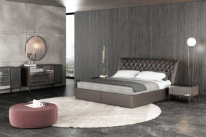 contemporary bedroom design with a blacl leather tufted upholstered bed dark wall and a round gray area rug