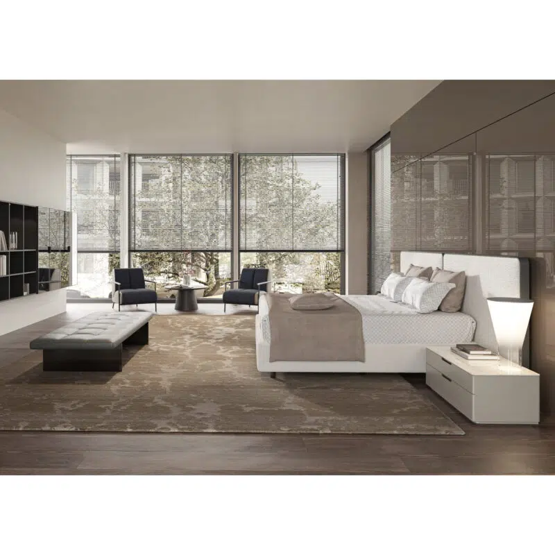 Modern bedroom with luxury beige upholstered bed, sleek nightstand, and elegant seating at LEOPARD Furniture, Canada.