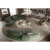 Elegant curved green sectional sofa in modern living room by LEOPARD Furniture Canada, featuring unique minimalist design.