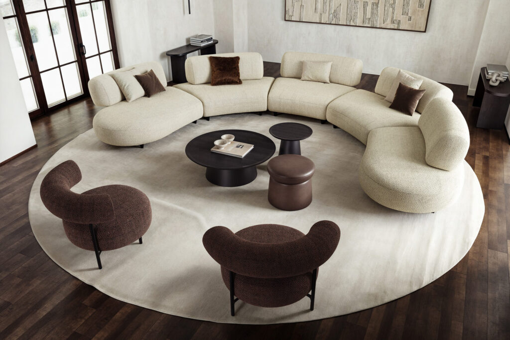 Luxurious curved sectional sofa with modern accent chairs by LEOPARD Furniture in elegant Canadian interior design setting.