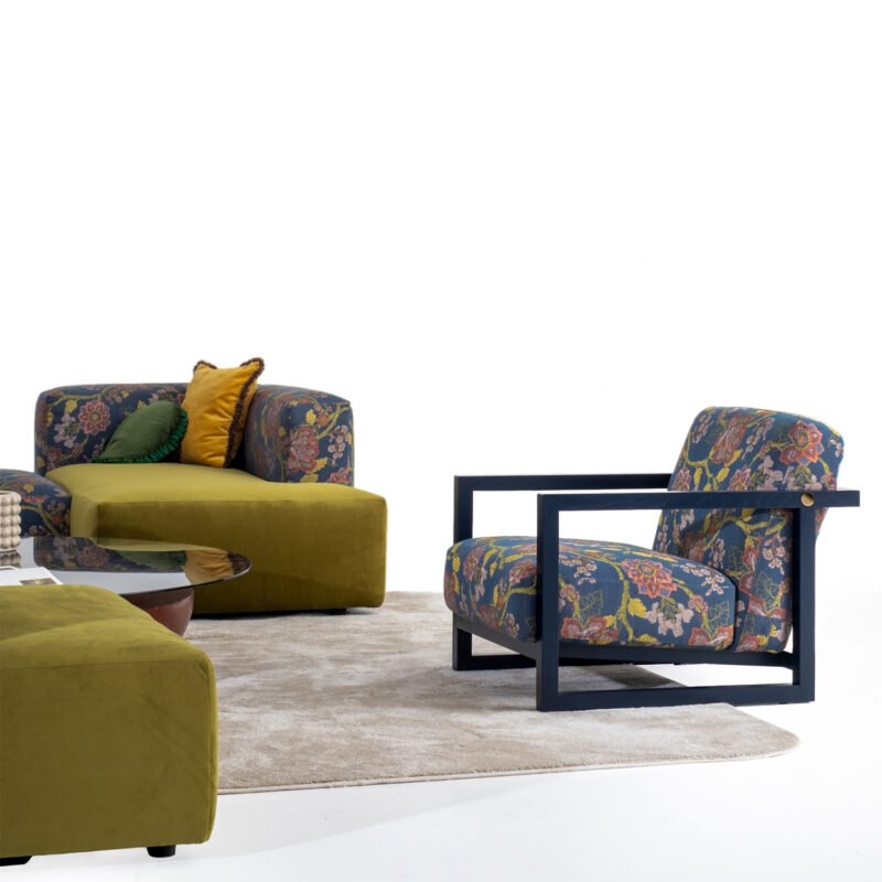 Modern living room with designer floral armchair and olive green sectional by LEOPARD Furniture. Luxurious elegance.