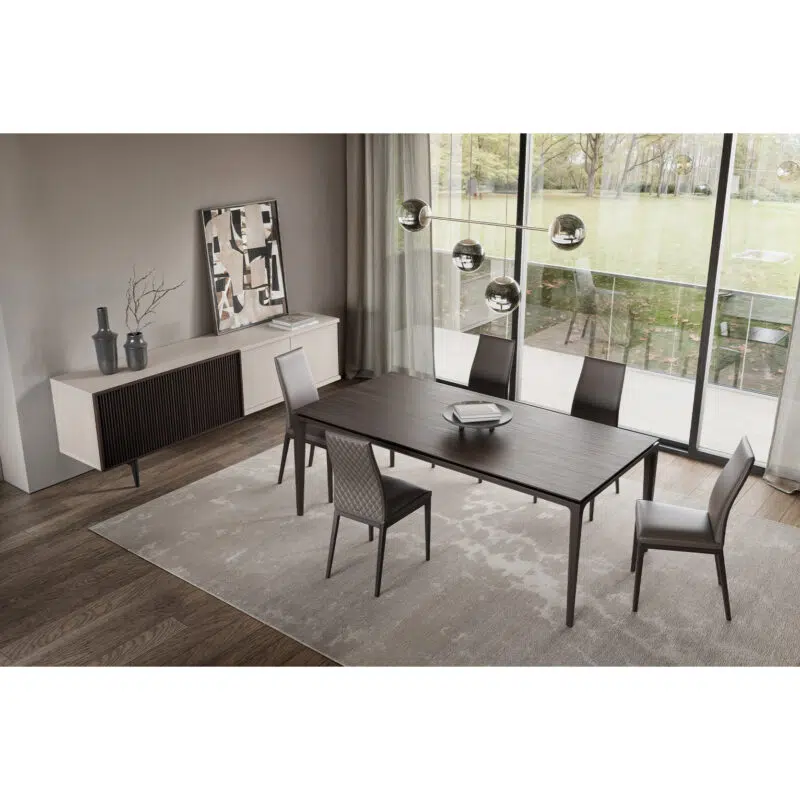 Modern dining room setup from LEOPARD Furniture, featuring elegant dark wood table and chairs with floor-to-ceiling windows.