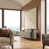Luxurious modern living room with LEOPARD Furniture TV stand as a low sideboard and abstract art, panoramic window view. Taupe color Italian ceramic TV stand.