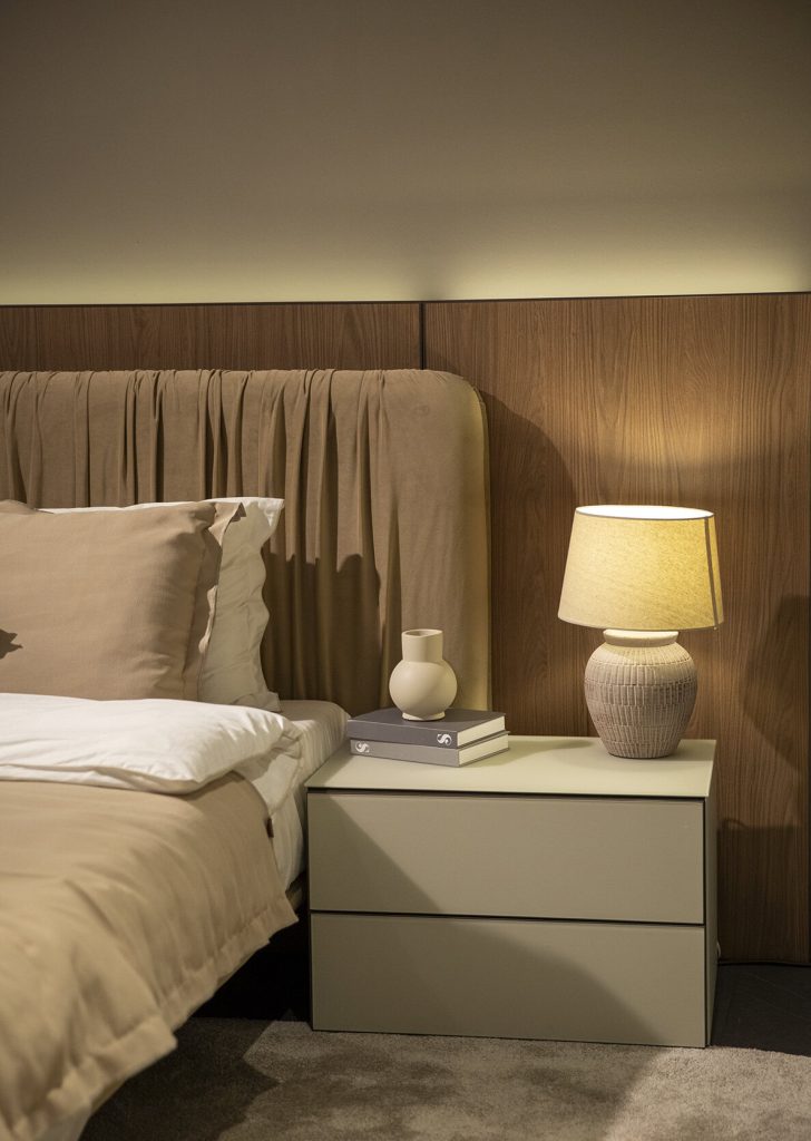 Elegant bedroom setup with modern nightstand and table lamp by LEOPARD Furniture, showcasing luxury interior design.