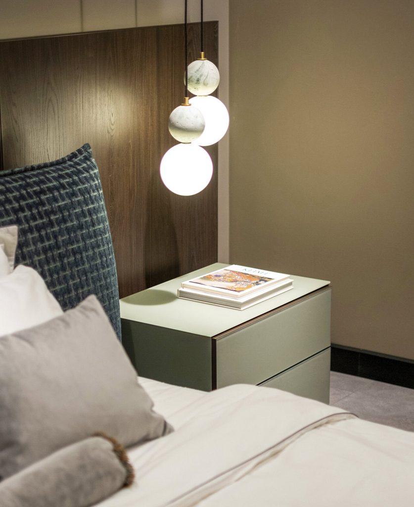 Modern bedroom with designer bedside table and pendant lights by LEOPARD Furniture, Canada. Luxury interior decor.