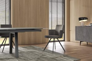 Modern dining area with sleek grey chairs and minimalist table by LEOPARD Furniture, featuring contemporary wood paneling.