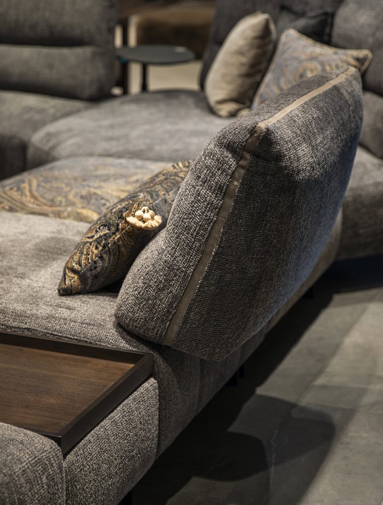 Luxury grey sectional sofa with ornate cushions at LEOPARD Furniture, high-end modern living room design.