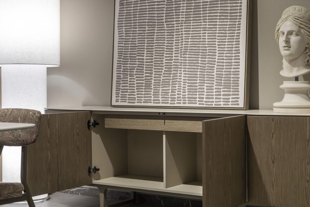 Modern sideboard cabinet with open doors, abstract art, and bust sculpture by LEOPARD Furniture Canada. Sophisticated decor.